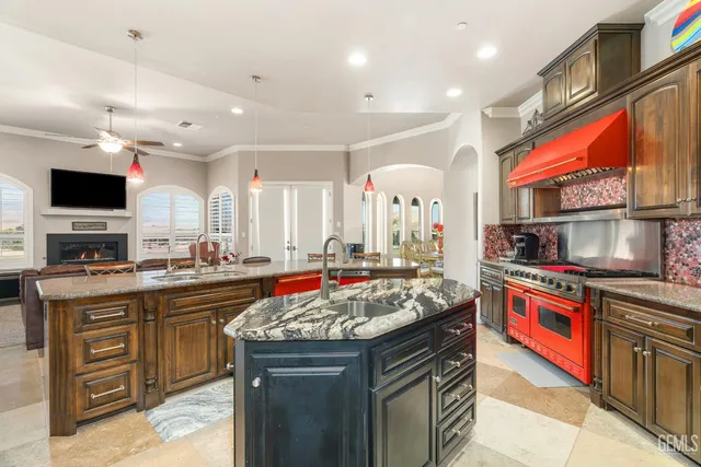 a kitchen with granite countertop a table chairs in it and wooden floors