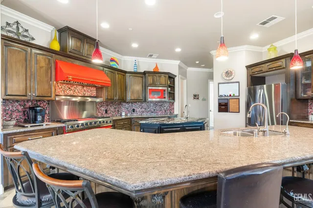 a kitchen with stainless steel appliances granite countertop a sink dishwasher stove and oven