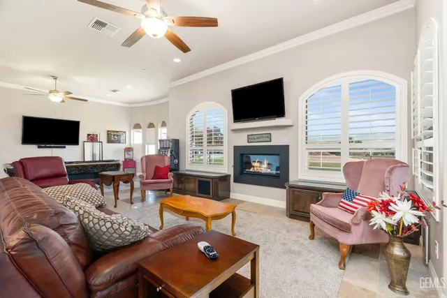 a living room with furniture fireplace and flat screen tv
