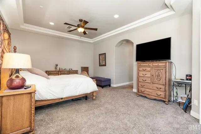 a spacious bedroom with a bed and a walk in closet