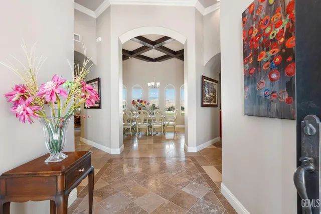 a view of a dining room with furniture and chandelier