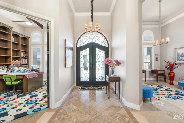 a dining room with furniture a chandelier and a rug
