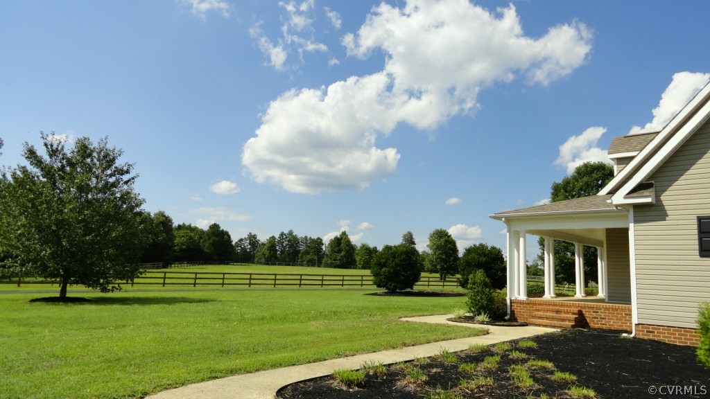 4647 The Falls Road Crewe, VA 23930 - Photo 6 of 23 a view of a white house with a big yard and potted plants