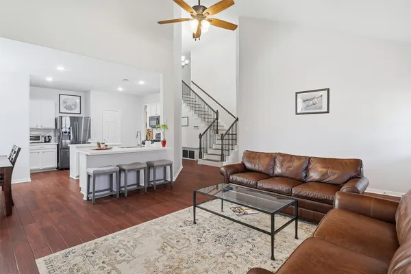 a living room with furniture and a wooden floor