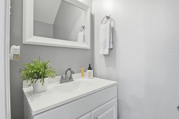 a bathroom with a sink and vanity