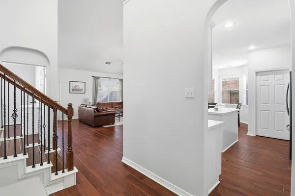 a view of a living room and dining room with wooden floor