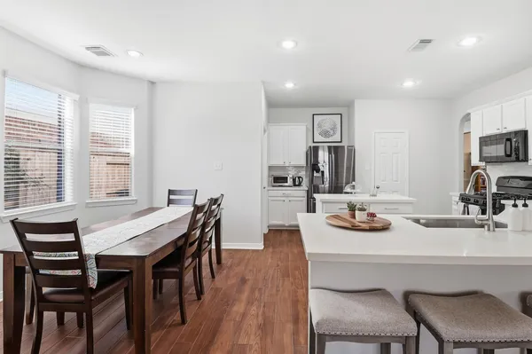 a view of a dining room with furniture and wooden floor