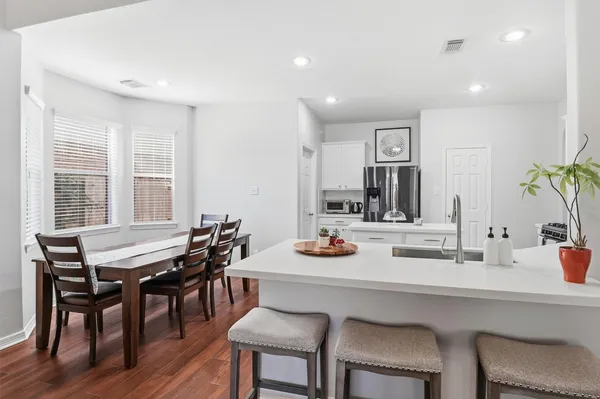 a view of a dining room and livingroom with furniture window and wooden floor