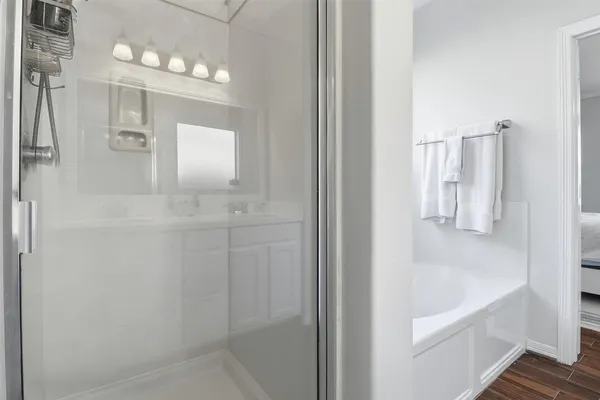 a bathroom with a bathtub and a shower