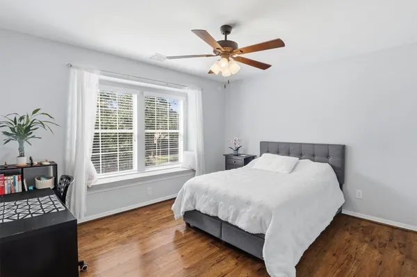 a living room with furniture ceiling fan and a rug