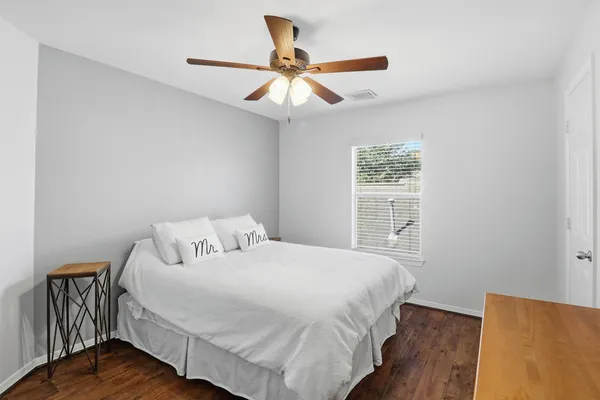 a bedroom with a bed and a window