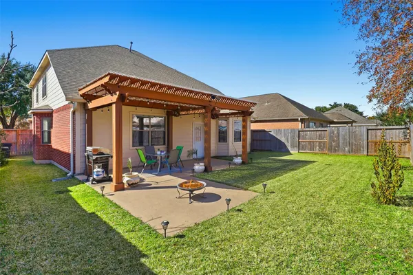 a view of a patio with a table chairs and a backyard