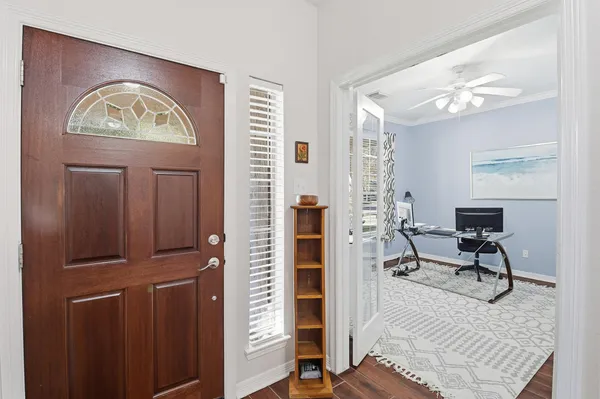 a view of hall way with furniture and mirror
