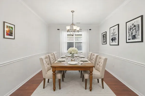 a view of a dining room with furniture window and wooden floor