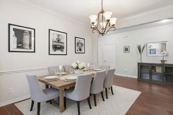 a view of a dining room with furniture wooden floor and chandelier