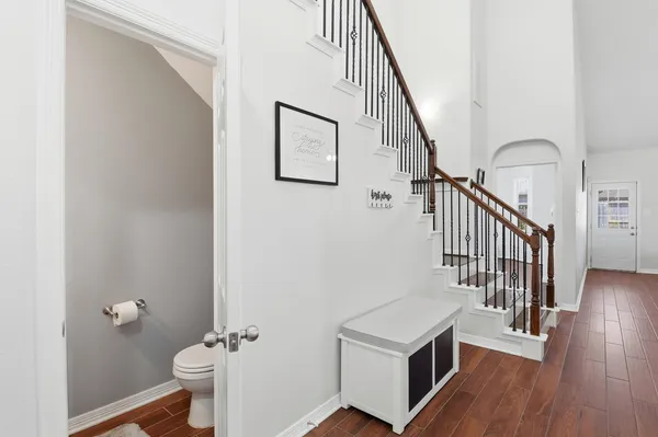 a view of a hallway with an entryway and wooden floor