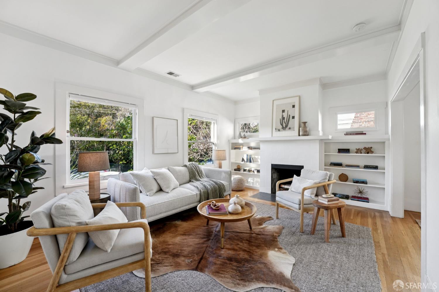a living room with furniture a fireplace and a large window
