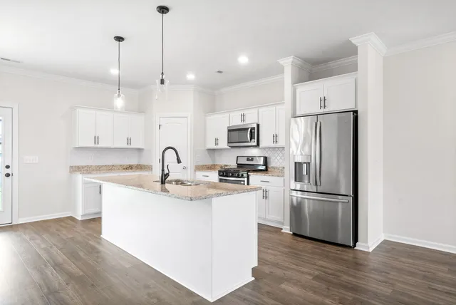 a view of a kitchen with granite countertop stainless steel appliances and wooden floor