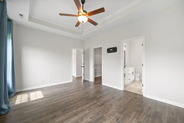 a bathroom with double vanity sink a mirror and a toilet