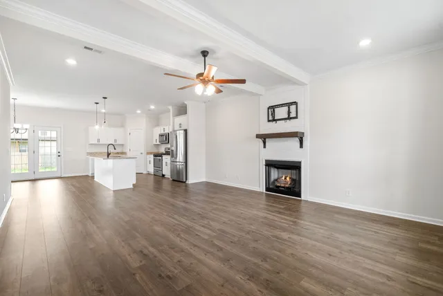 a view of a hallway with a white wall and a fireplace