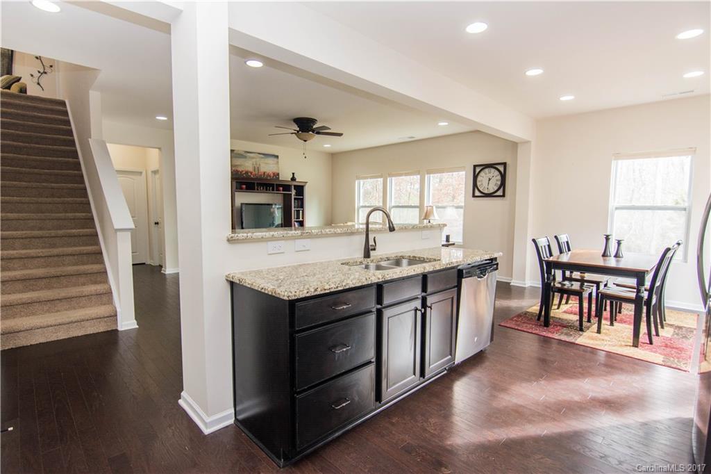 1689 Beleek Ridge Lane Clover, SC 29710 - Photo 2 of 24 a large kitchen with kitchen island a sink a stove a dining table and chairs