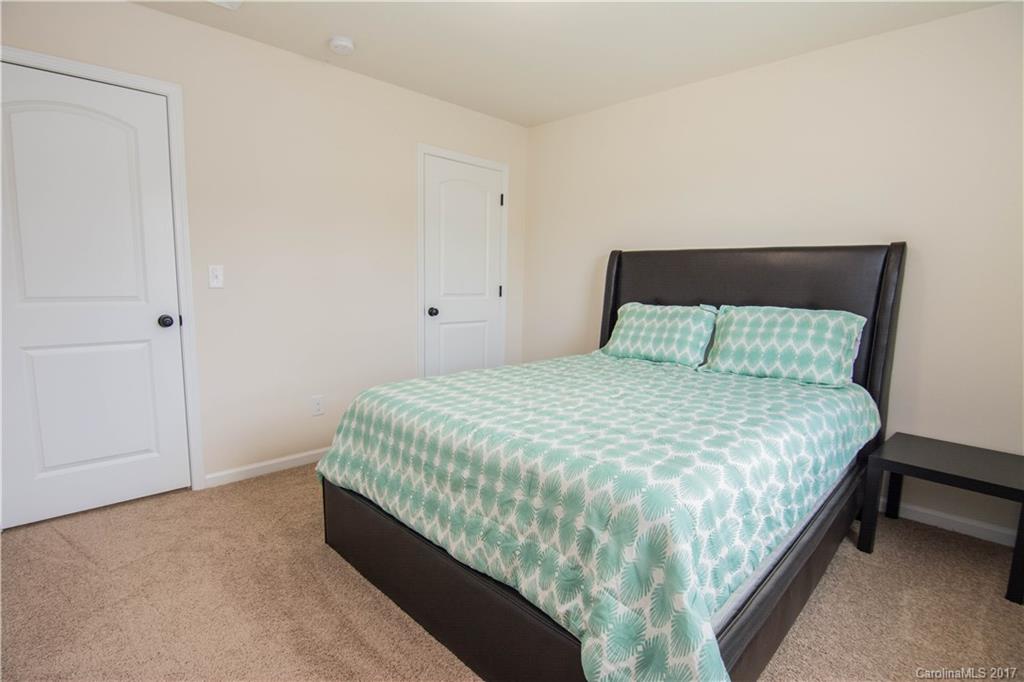 1689 Beleek Ridge Lane Clover, SC 29710 - Photo 18 of 24 a large bed sitting in a bedroom next to a cabinet