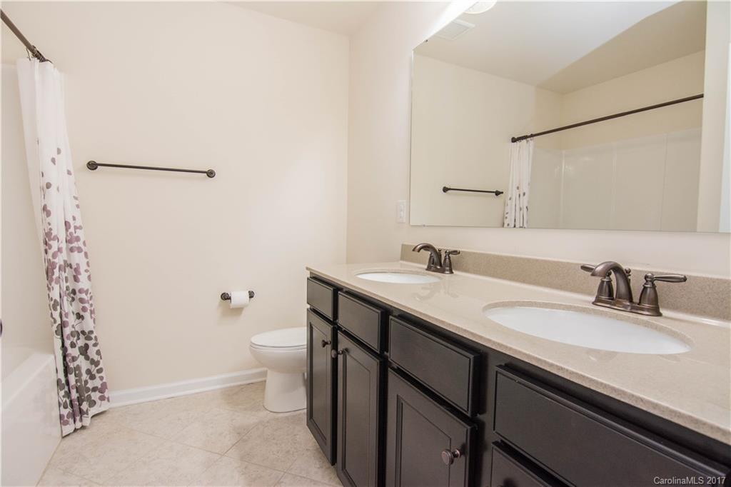 1689 Beleek Ridge Lane Clover, SC 29710 - Photo 19 of 24 a bathroom with a sink a toilet a shower and a mirror