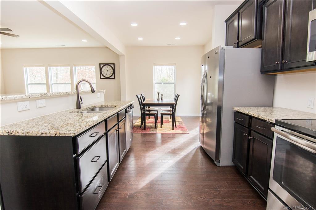 1689 Beleek Ridge Lane Clover, SC 29710 - Photo 4 of 24 a kitchen with granite countertop a refrigerator a stove top oven a sink and dishwasher