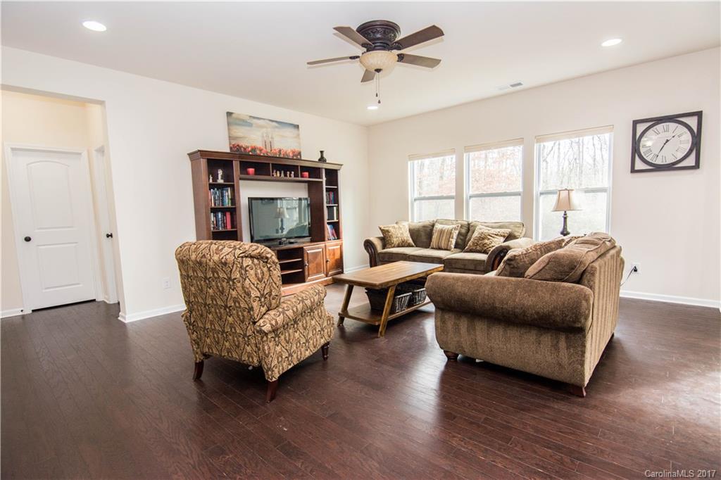 1689 Beleek Ridge Lane Clover, SC 29710 - Photo 9 of 24 a living room with furniture a ceiling fan a wooden floor and a window