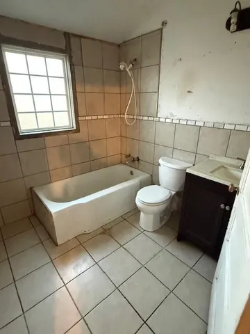 a bathroom with a toilet sink and a window