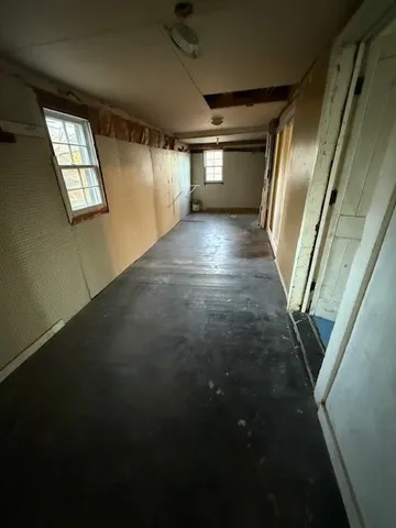 a room with wooden floor and furniture