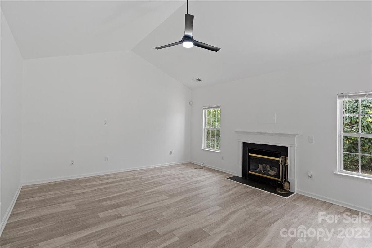 1007 Reigate Road Charlotte, NC 28262 - Photo 11 of 28 a view of wooden floor fire place and windows in a room