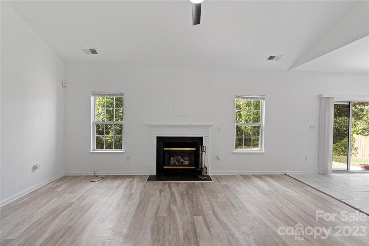 1007 Reigate Road Charlotte, NC 28262 - Photo 12 of 28 an empty room with windows and fireplace