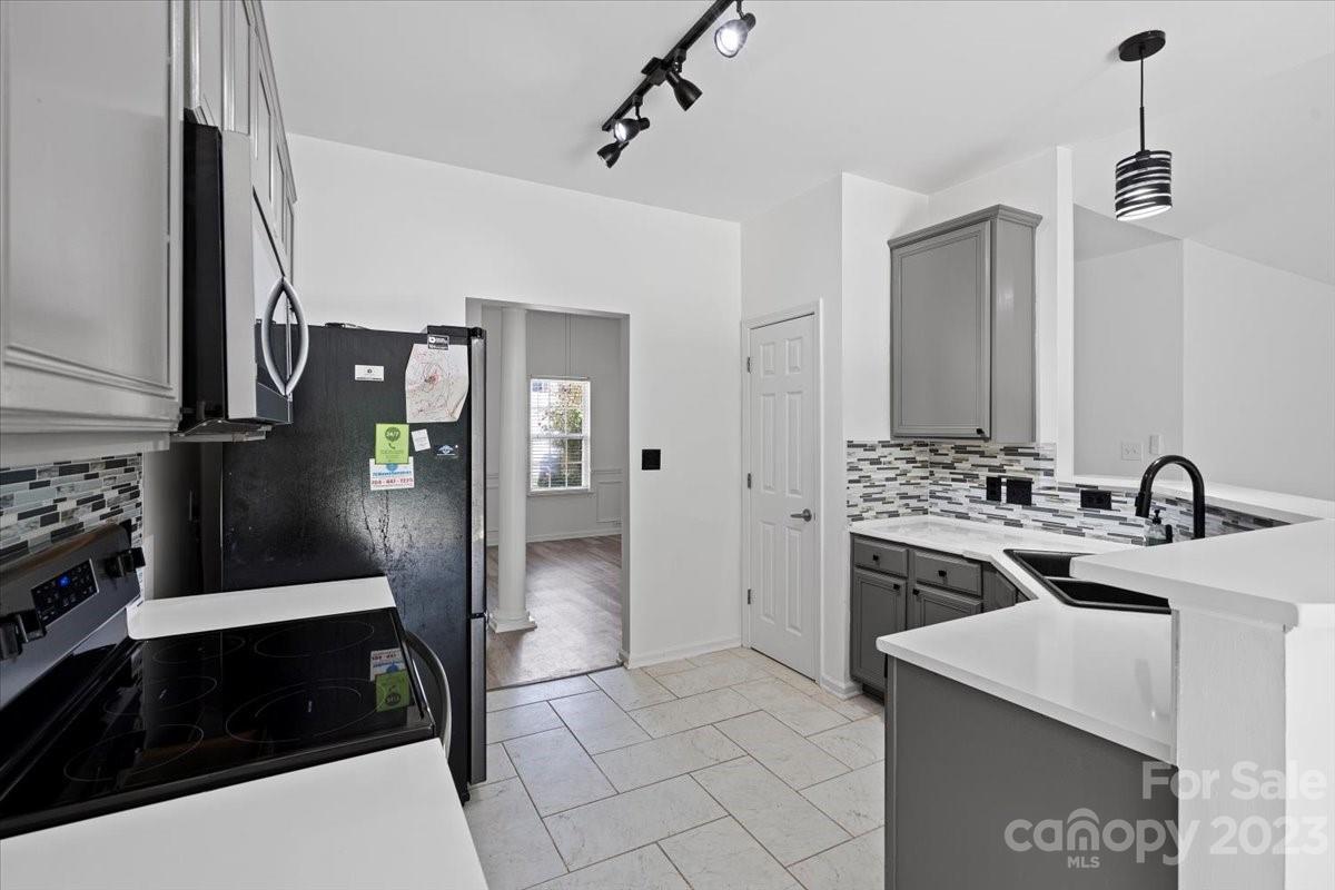 1007 Reigate Road Charlotte, NC 28262 - Photo 15 of 28 a kitchen with stainless steel appliances kitchen island a stove a refrigerator and a sink