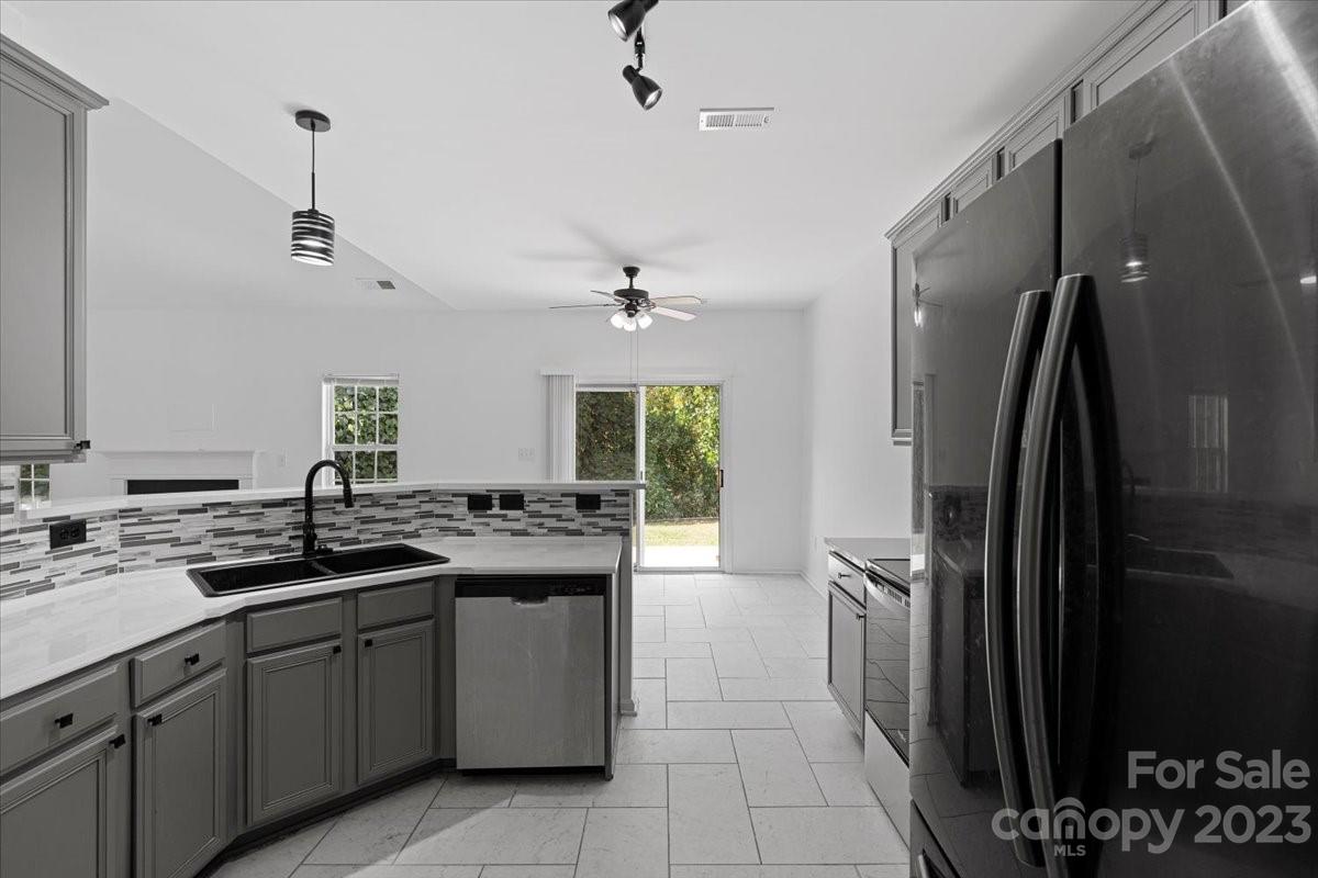 1007 Reigate Road Charlotte, NC 28262 - Photo 16 of 28 a kitchen with a sink stainless steel appliances and cabinets