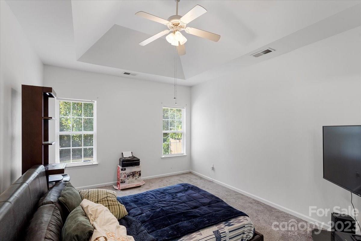 1007 Reigate Road Charlotte, NC 28262 - Photo 17 of 28 a bedroom with a bed window and a flat screen tv