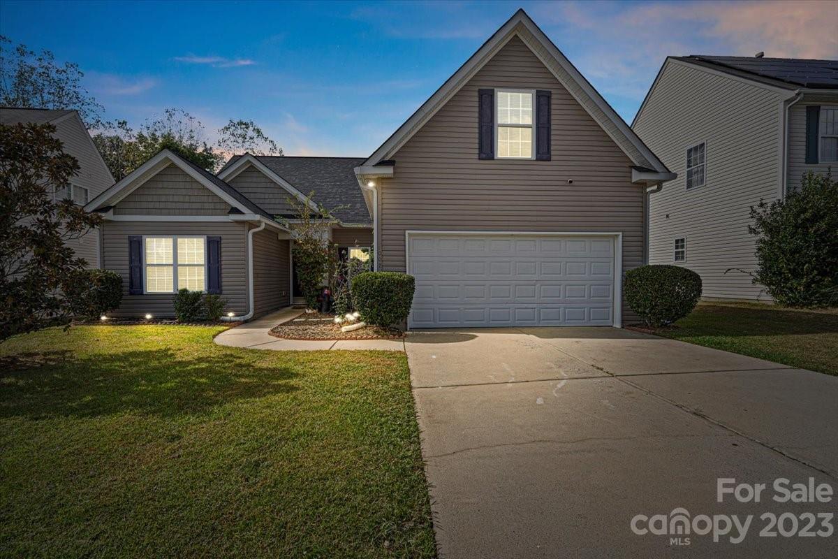 1007 Reigate Road Charlotte, NC 28262 - Photo 3 of 28 a front view of a house with a yard and garage