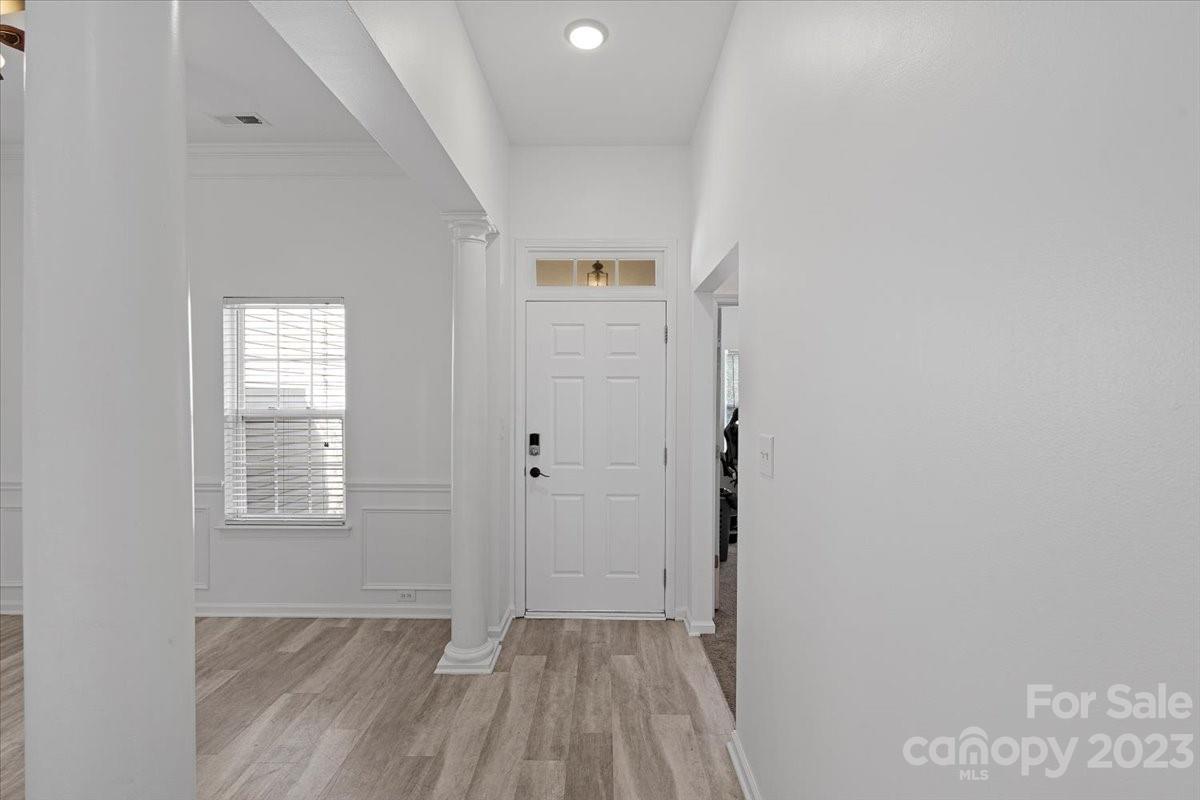 1007 Reigate Road Charlotte, NC 28262 - Photo 6 of 28 a view of hallway with window and wooden floor