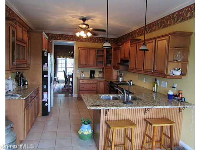 2027 Tillotson Road Pinnacle, NC 27043 - Photo 13 of 16 Kitchen. Gorgeous kitchen w/tons cabinets,granite,eat-in bar &more!