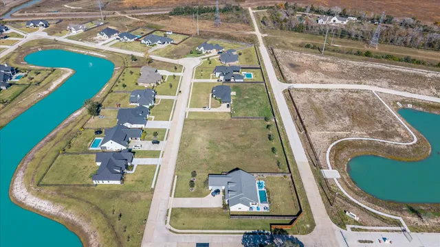an aerial view of a pool patio chairs and fire pit