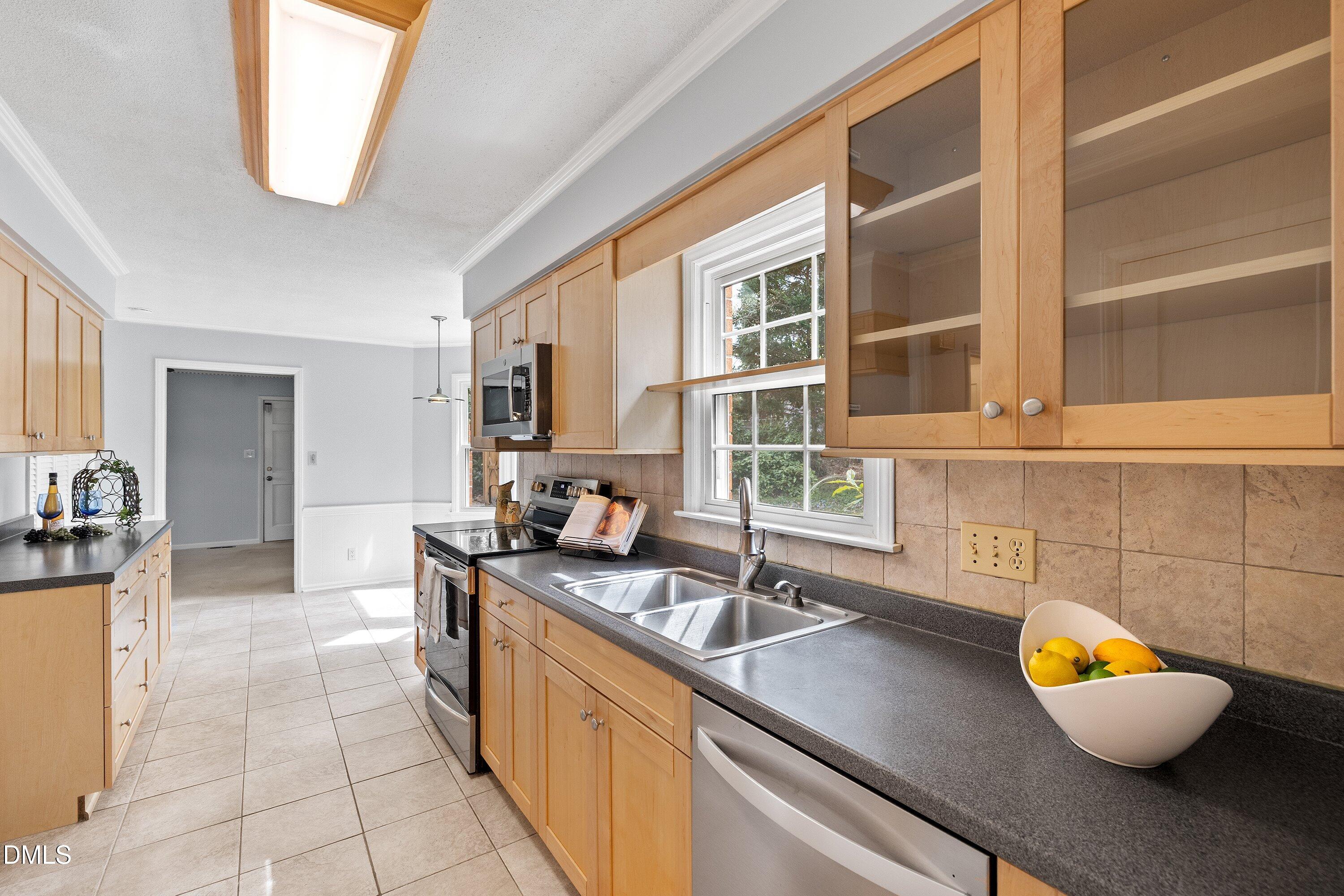 400 Cedar Hill Lane Raleigh, NC 27609 - Photo 14 of 41 a kitchen with a sink and a wooden cabinets