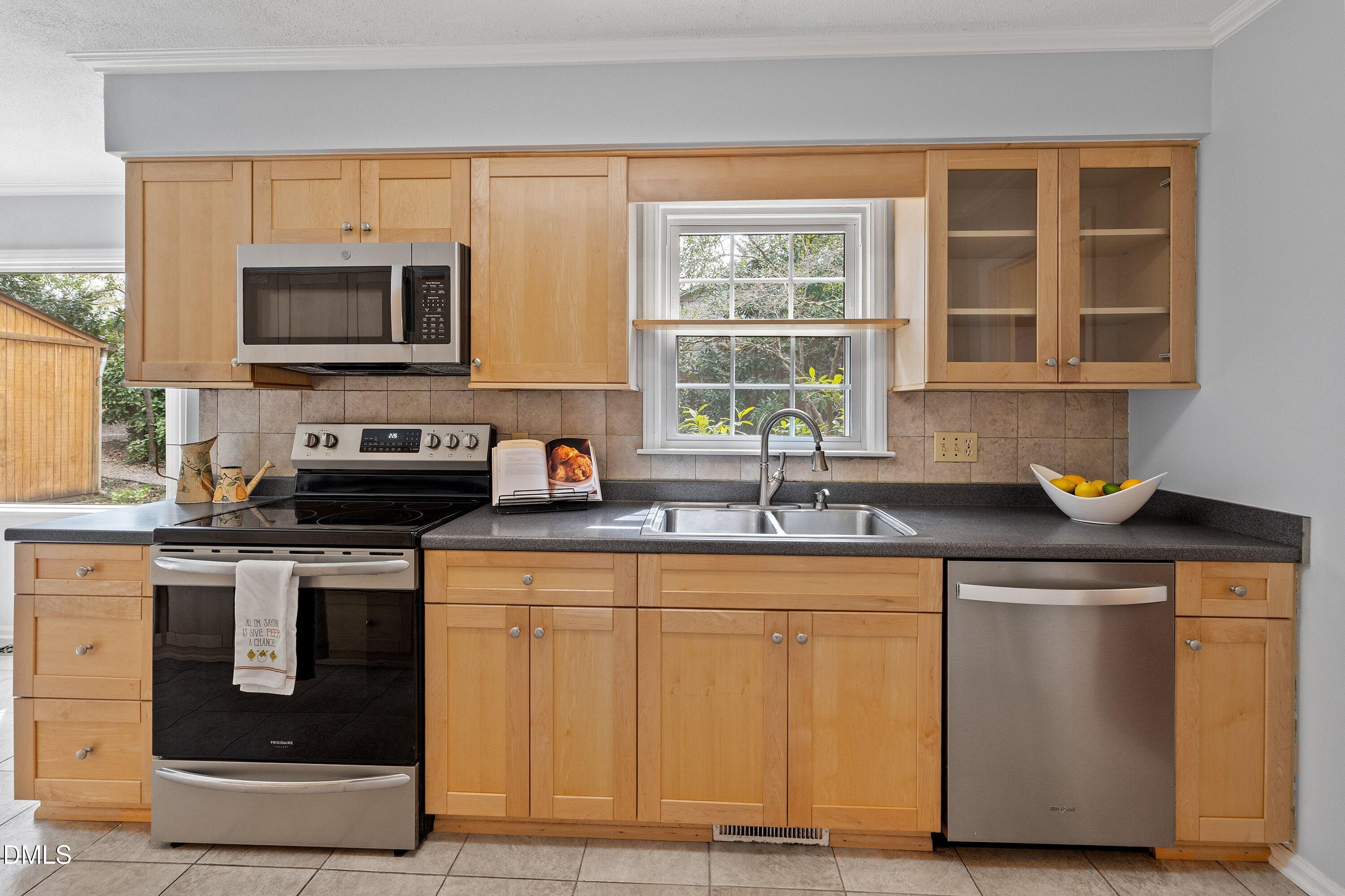 400 Cedar Hill Lane Raleigh, NC 27609 - Photo 15 of 41 a kitchen with stainless steel appliances granite countertop a stove a sink and a microwave