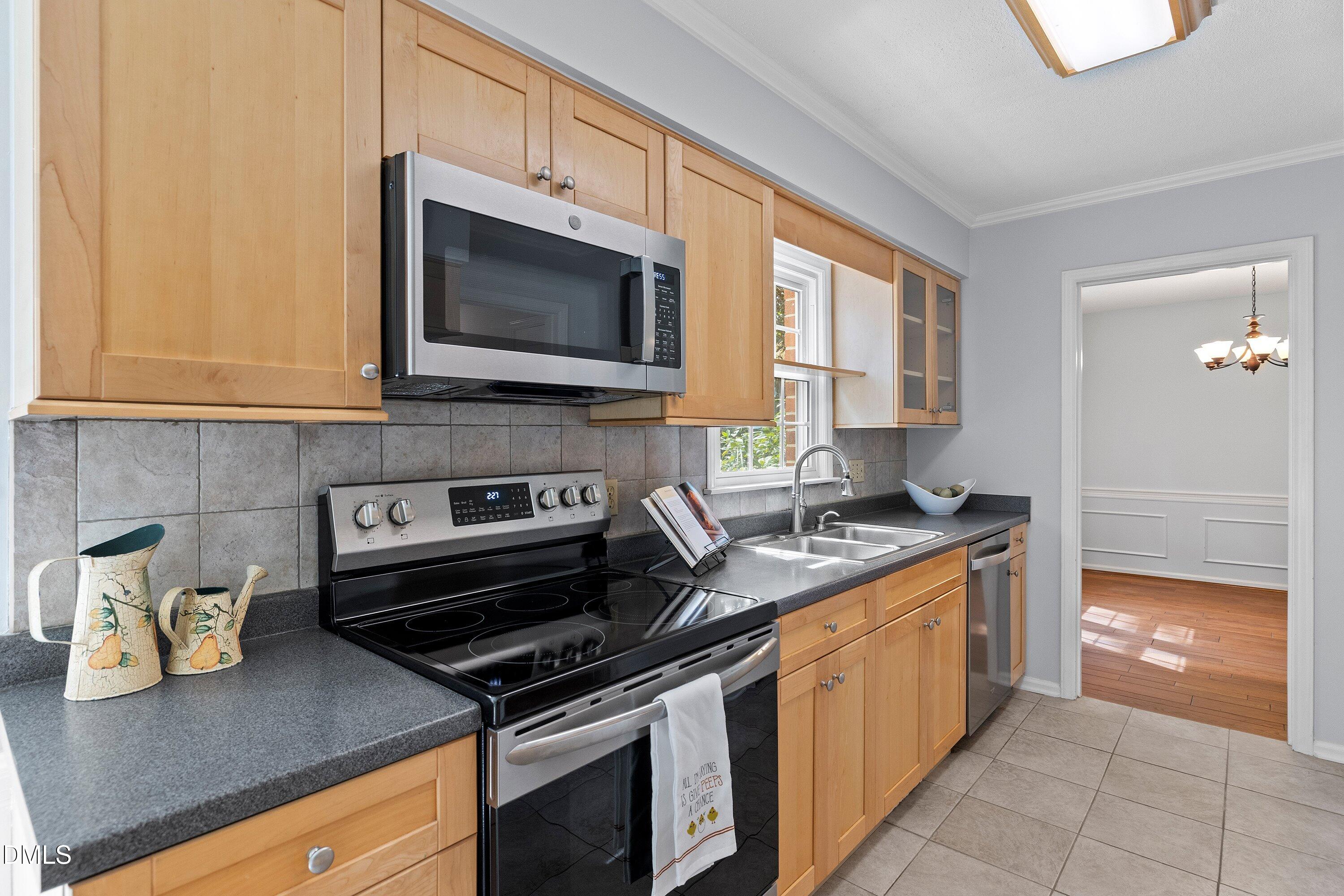 400 Cedar Hill Lane Raleigh, NC 27609 - Photo 17 of 41 a kitchen with stainless steel appliances granite countertop a stove a sink and a microwave