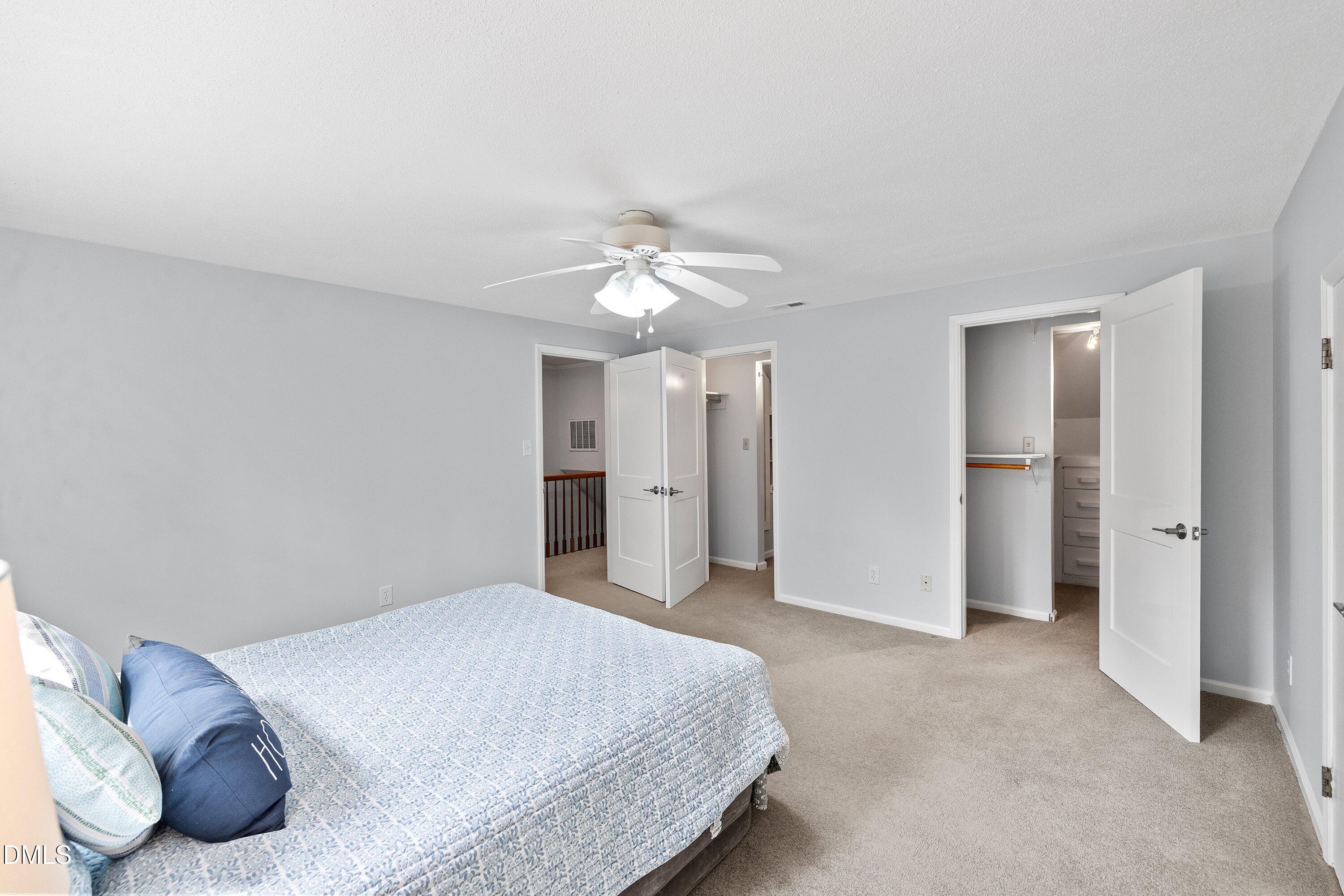 400 Cedar Hill Lane Raleigh, NC 27609 - Photo 35 of 41 a spacious bedroom with a bed and a ceiling fan