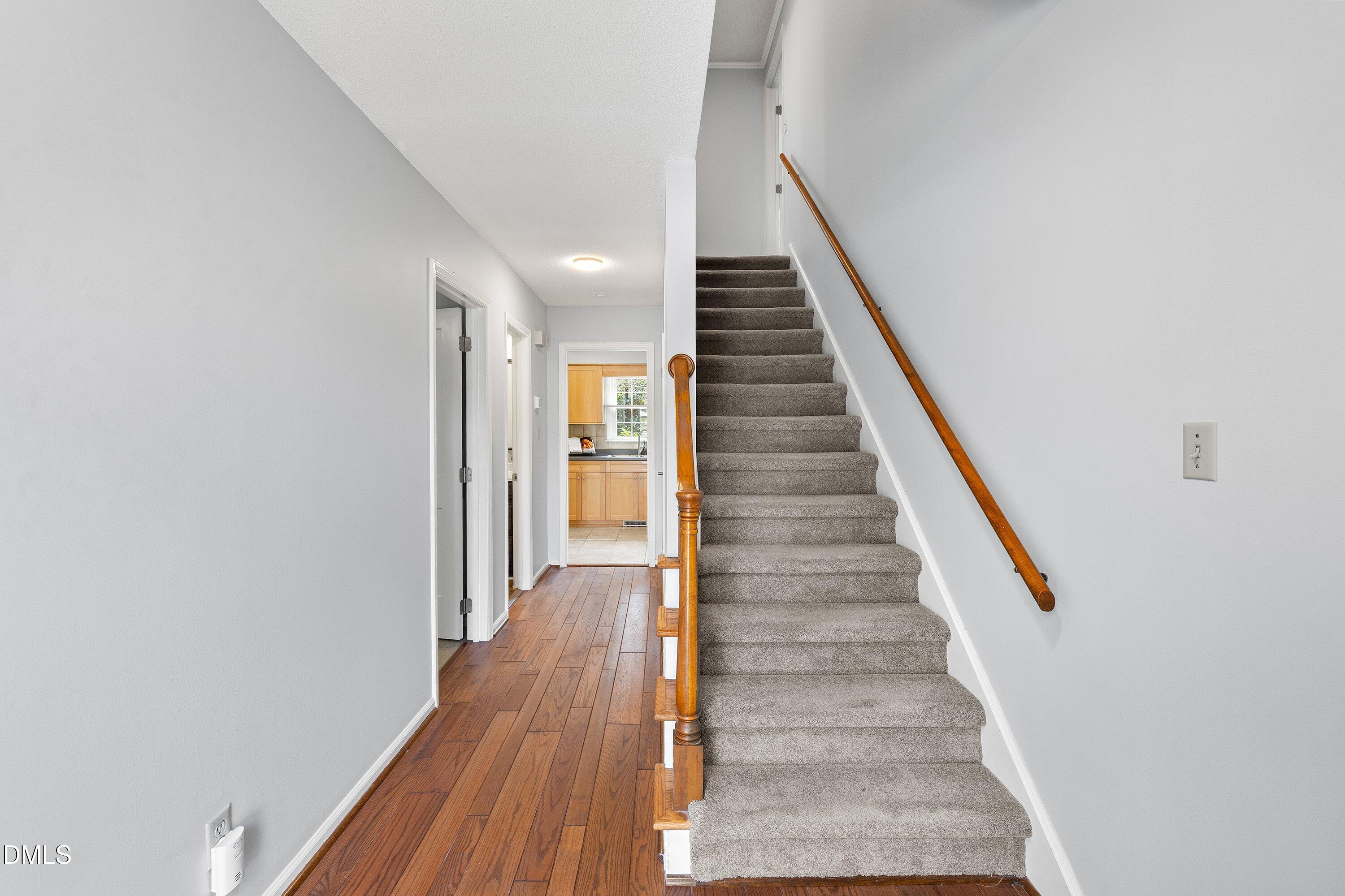 400 Cedar Hill Lane Raleigh, NC 27609 - Photo 5 of 41 a view of entryway and gallery with wooden floor