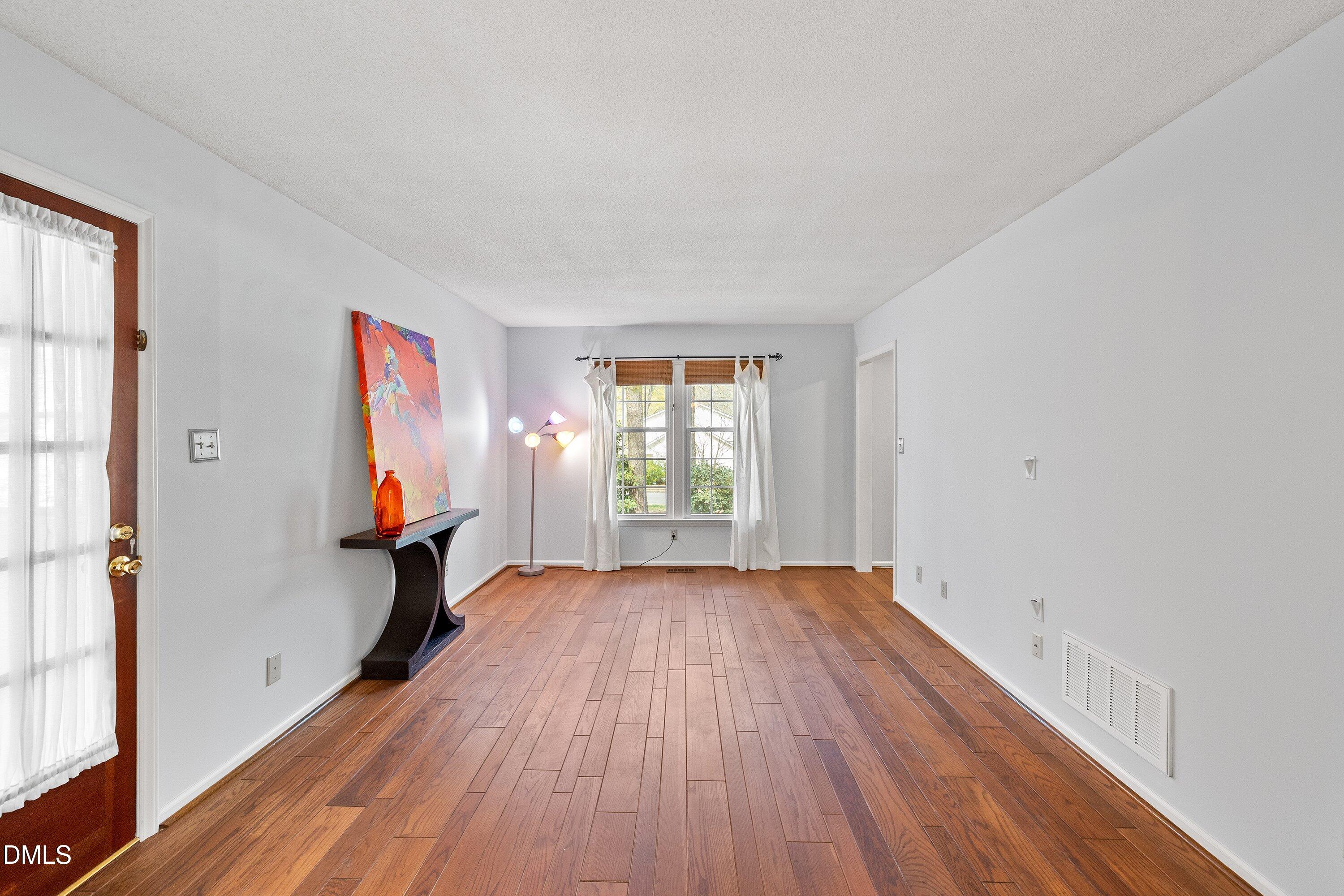 400 Cedar Hill Lane Raleigh, NC 27609 - Photo 8 of 41 a view of a room with wooden floor and a window