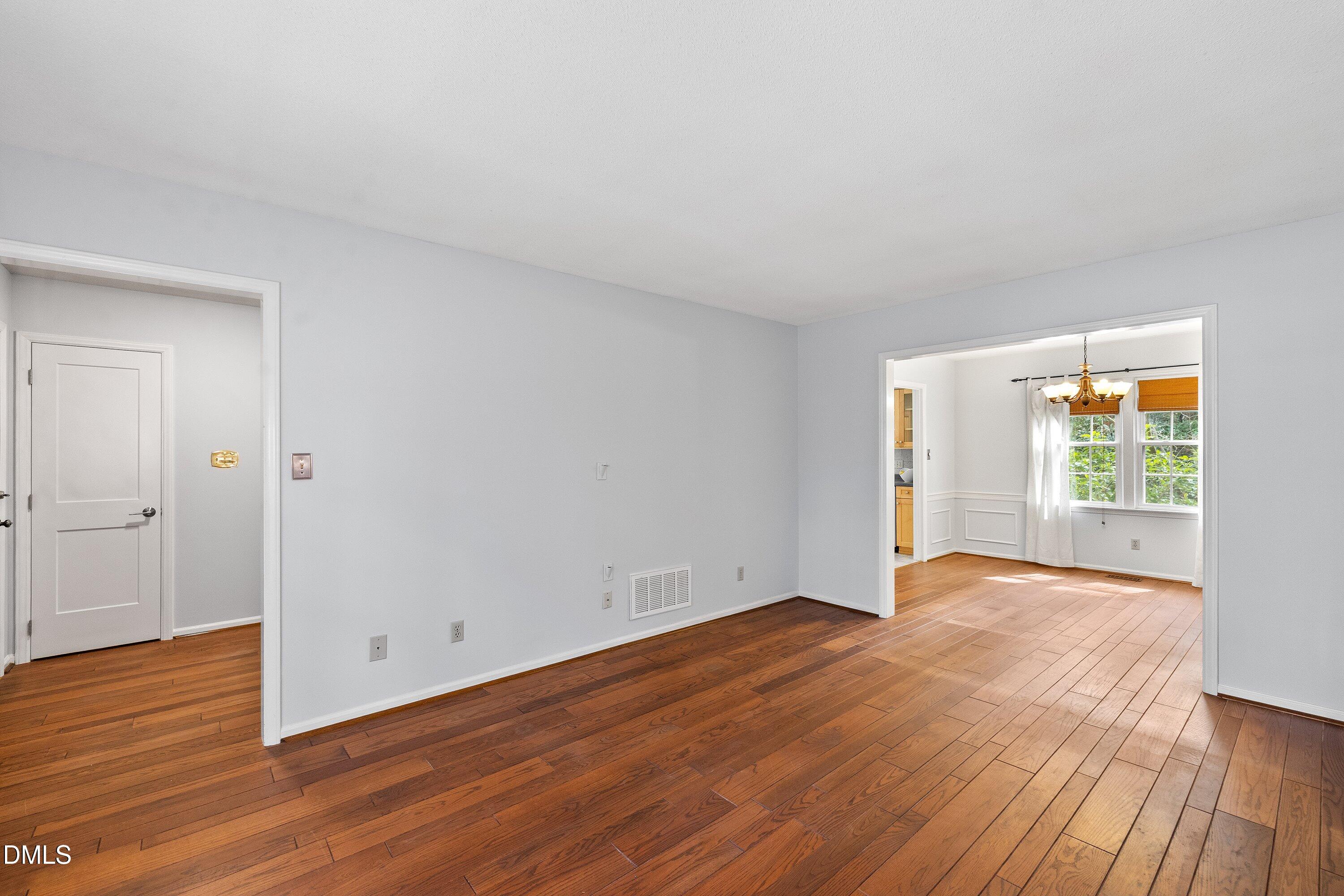 400 Cedar Hill Lane Raleigh, NC 27609 - Photo 9 of 41 a view of an empty room with wooden floor and a window
