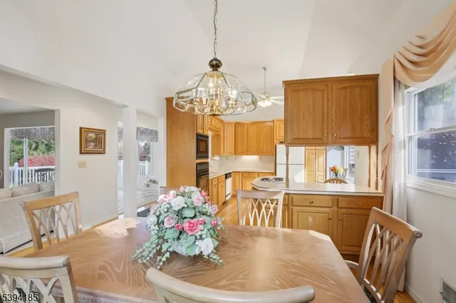 a dining room with furniture a window and wooden floor