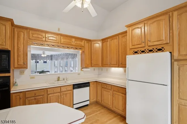 a kitchen with a refrigerator a sink and cabinets