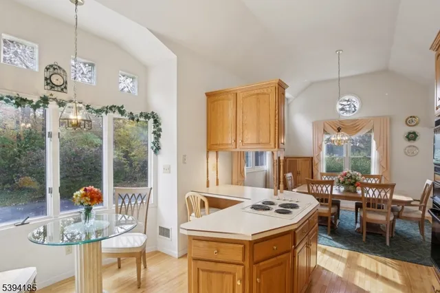 a kitchen with a stove a table and chairs